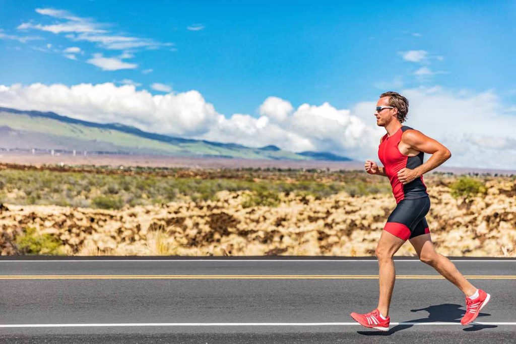 Runner training outdoors on a scenic road in Hawaii, representing an active island lifestyle