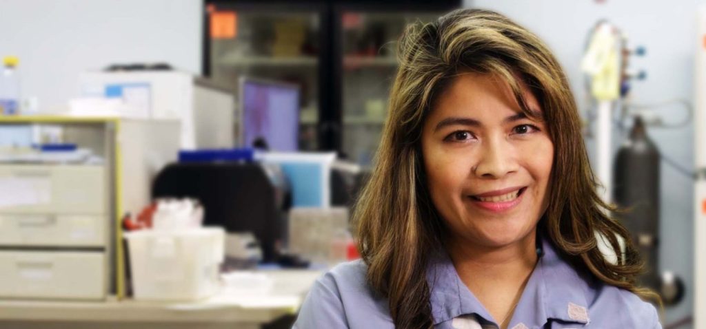 Joyce Iwata, Diagnostic Laboratory Services team member, featured in a career story in a laboratory environment